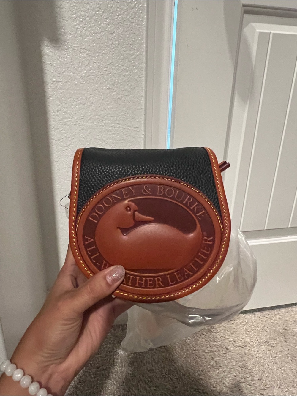 Dooney & Bourke Black and Brown Pebbled Leather Saddle Crossbody